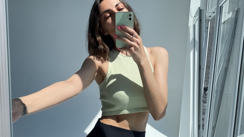 Woman in a sporty crop top and shorts